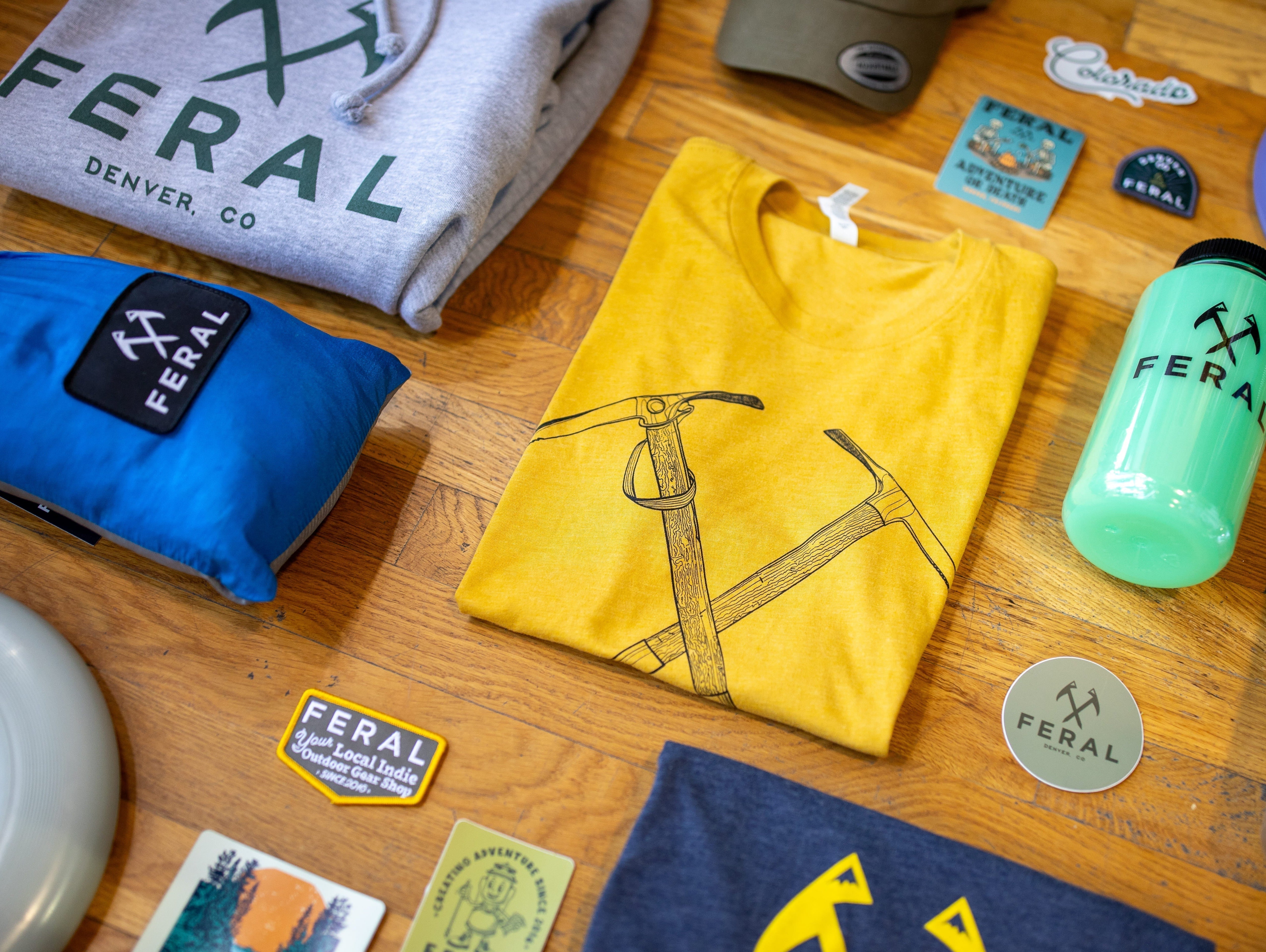 Lay-flat image of FERAL-branded shirts and gear items.