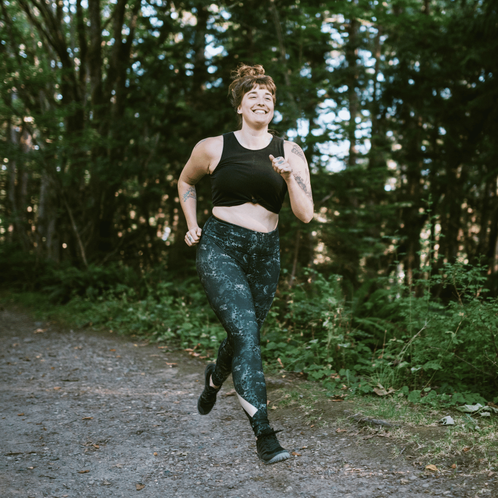 Person running on a path in a forest
