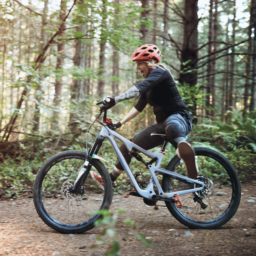 Person riding a mountain bike on a trail in a forest