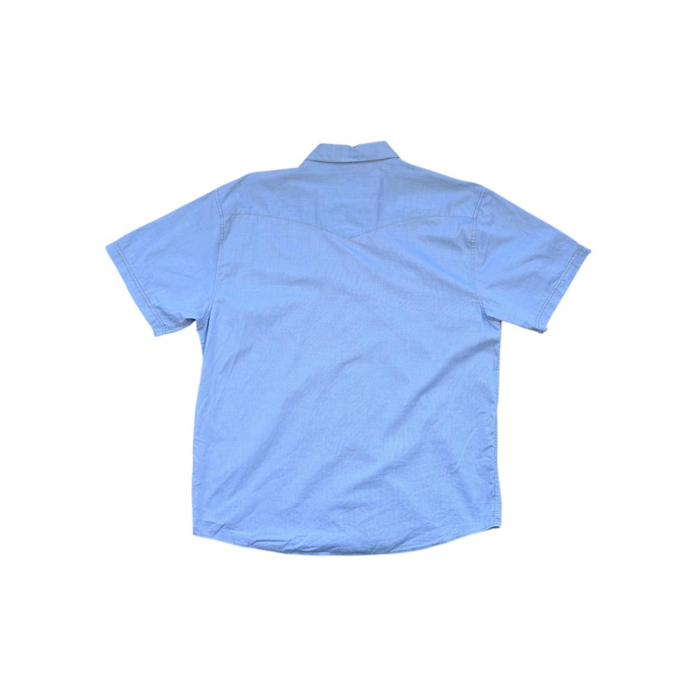 Light blue short sleeve shirt by Howler Bros featuring a western yoke and snap closures, back view.