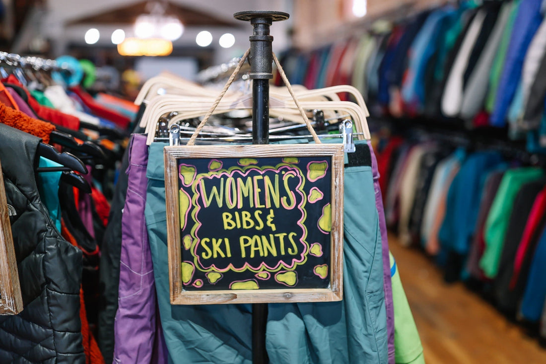 A section of used women's ski pants and ski bibs.