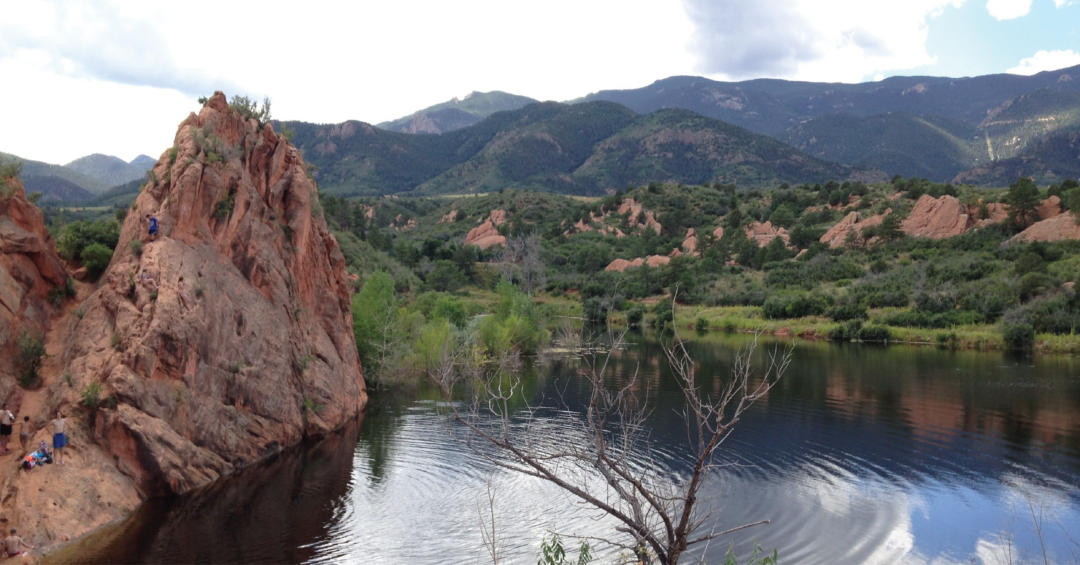 Hikers explore the red rock formations at Red Rock Canyon Open Space, a scenic Denver area destination for outdoor adventure.
