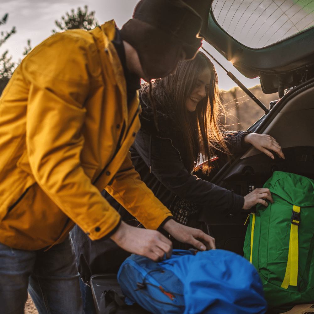 Travel-ready backpacks in green and blue, evoking an adventurous, outdoorsy mood.