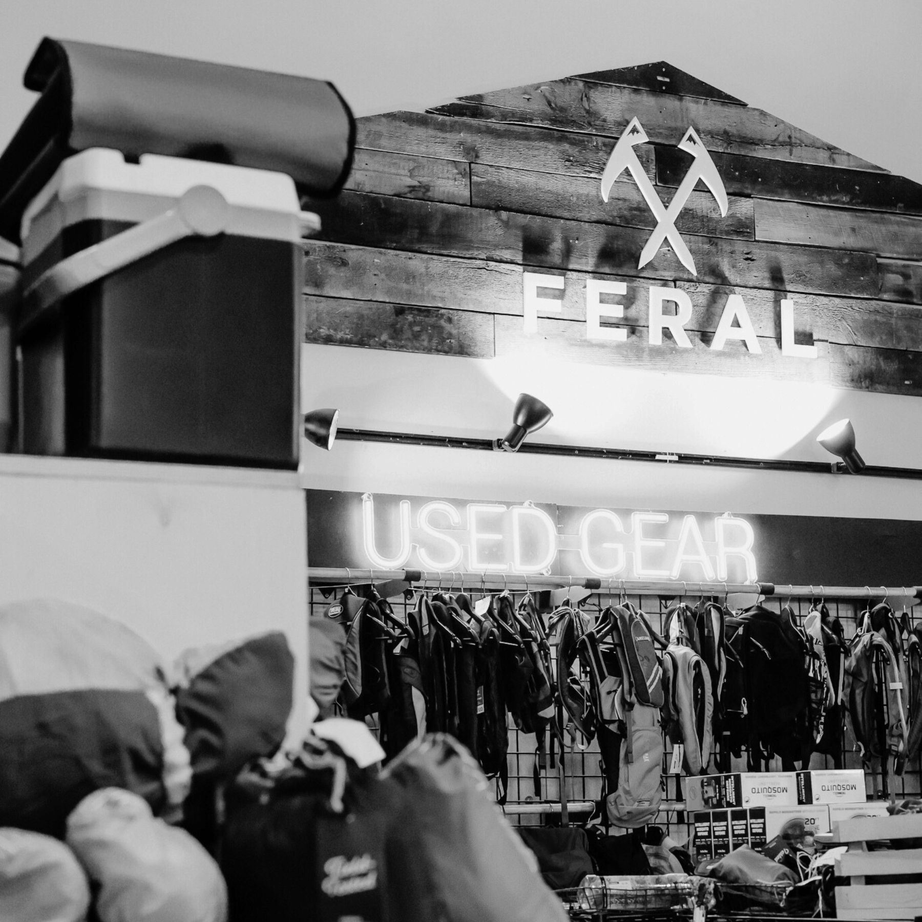 Vintage clothing store with 'Feral' sign and 'Used Gear' display.