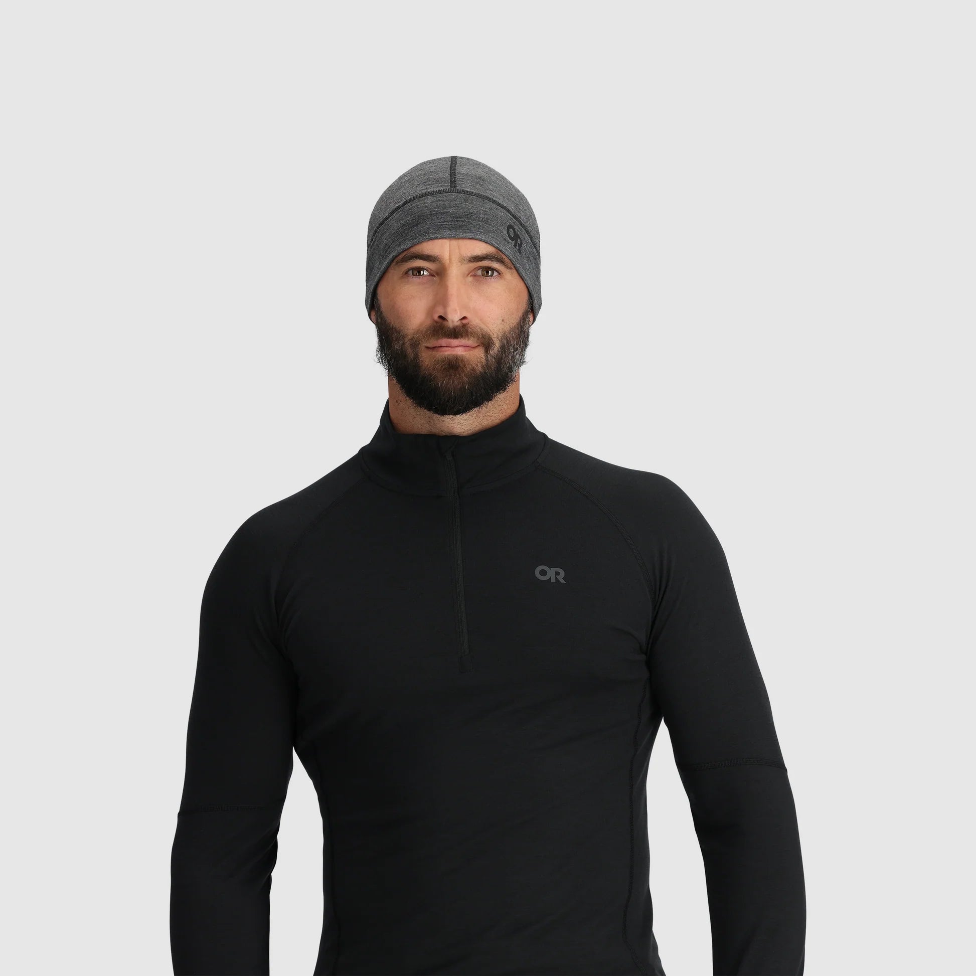 Gray beanie by Outdoor Research, styled on a man with a black long sleeve mock neck shirt.