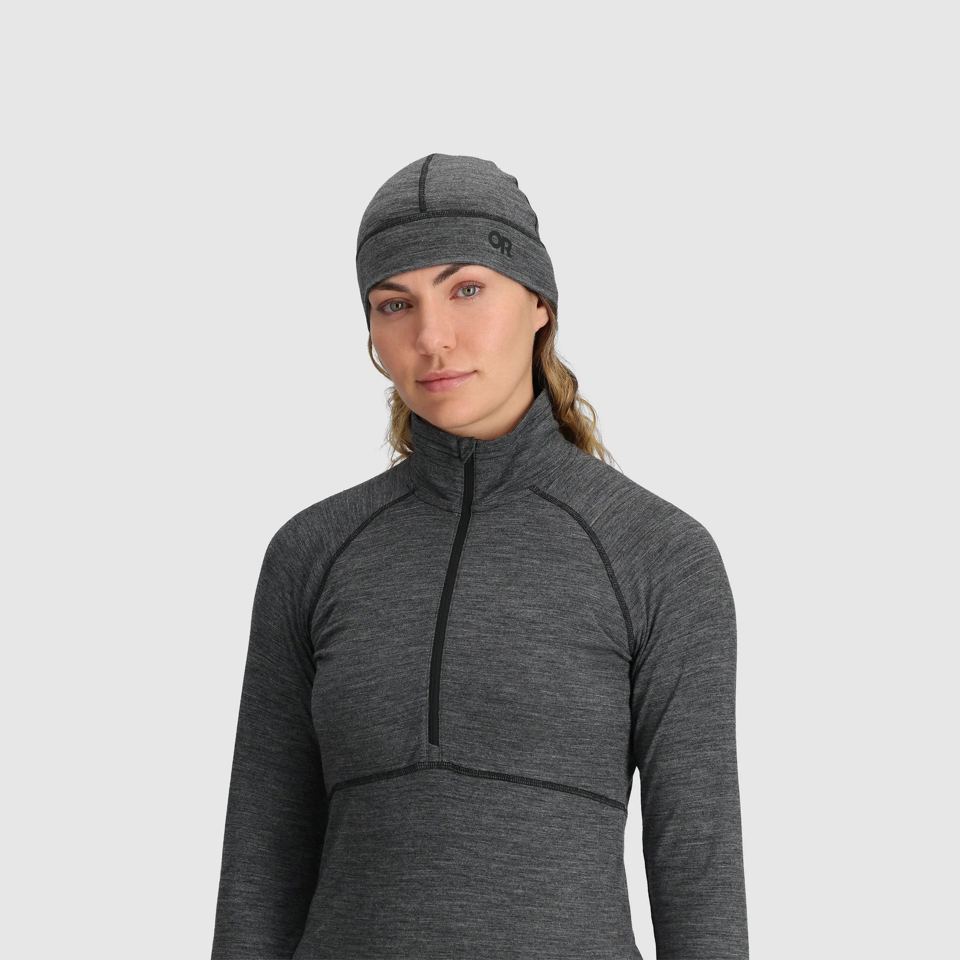 Gray merino beanie by Outdoor Research with logo detail, paired with a matching long sleeve top.