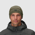 Olive green merino beanie by Outdoor Research, worn with a dark gray hooded jacket.