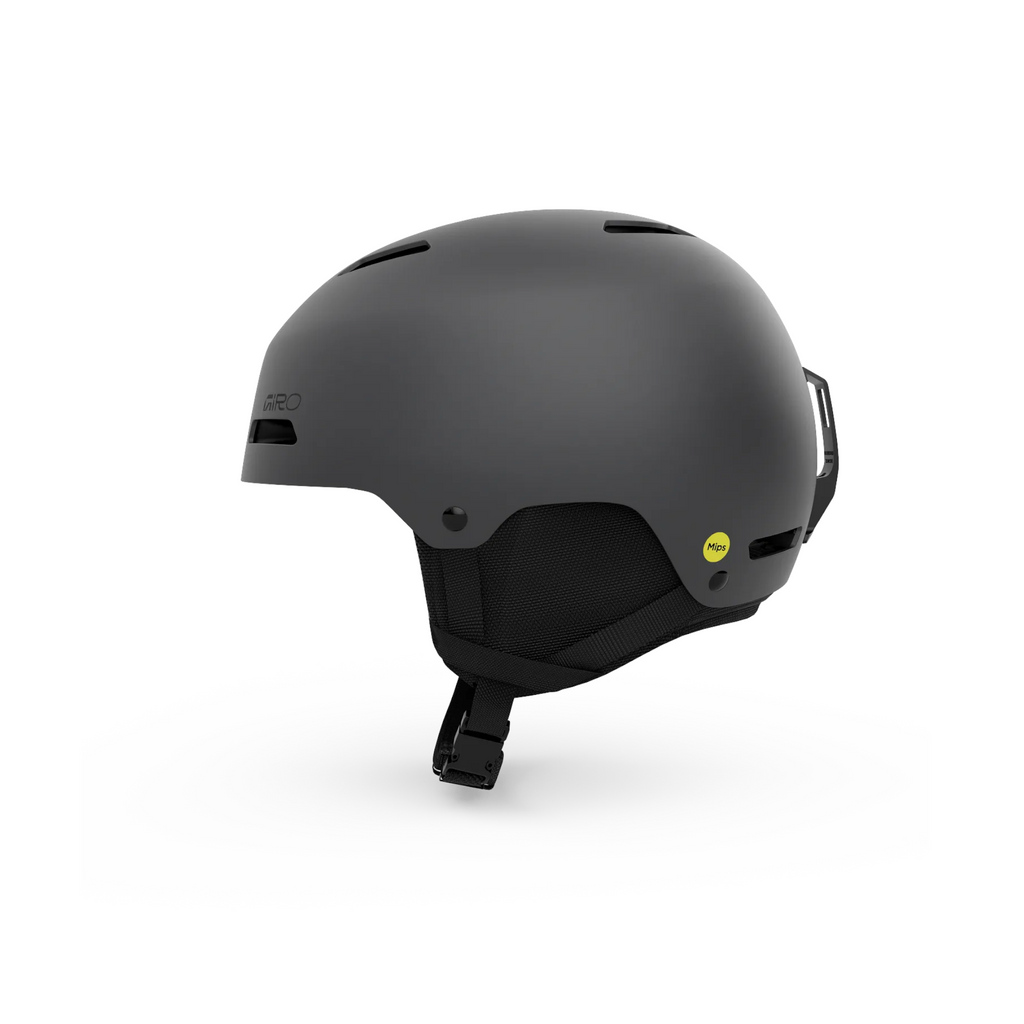 Matte grey ski helmet by Giro, with MIPS technology, ear pads, and adjustable chin strap.