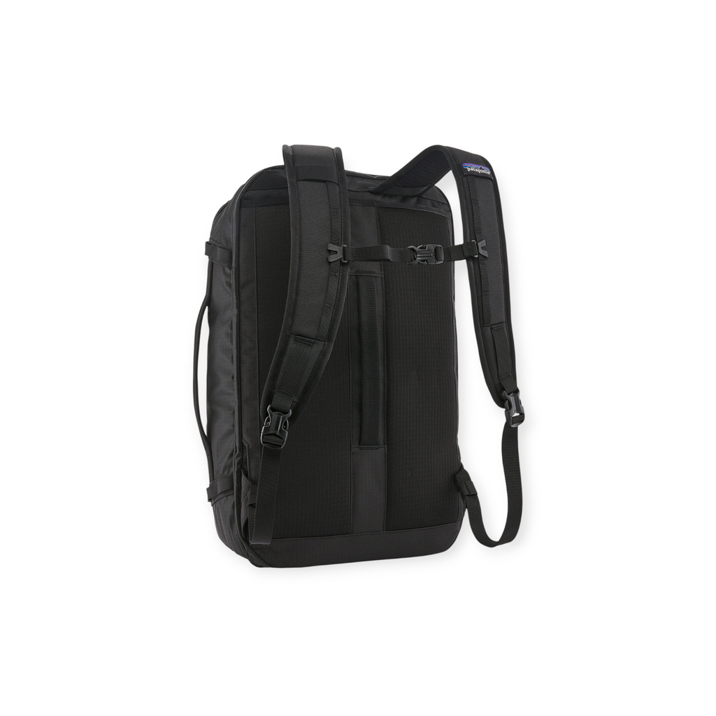 Black travel backpack in black by Patagonia, with padded shoulder straps and sternum strap, back view.