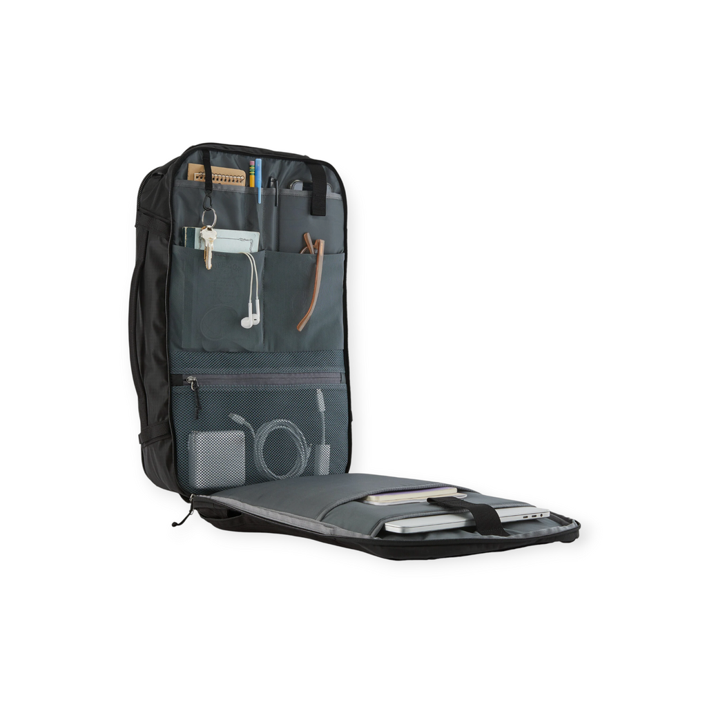 Open black backpack by Patagonia with multiple compartments and accessories inside.
