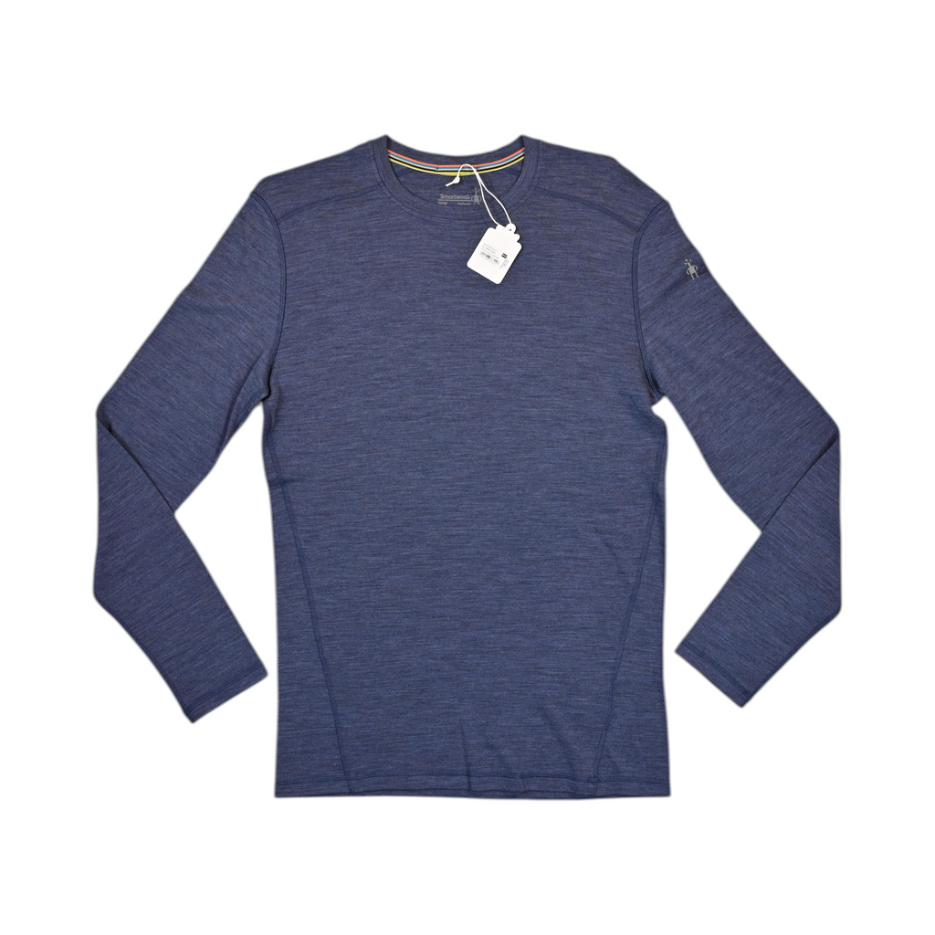 Heathered blue crew neck baselayer by Smartwool, laid flat with hangtag attached.