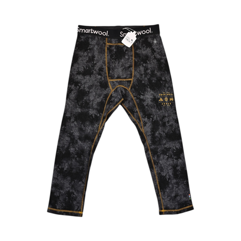 Black Tie Dye-Honey Gold Merino base layer pants by Smartwool, front view with gold contrast stitching down each leg.