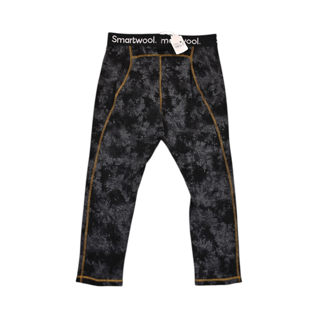 Black Tie Dye-Honey Gold Merino base layer pants by Smartwool, back view with gold contrast stitching down each leg.