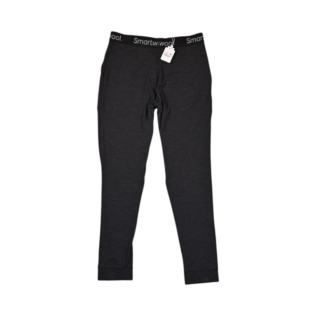 Charcoal Heather Merino jogger pants by Smartwool, front view with the elastic waistband and hangtag visible.