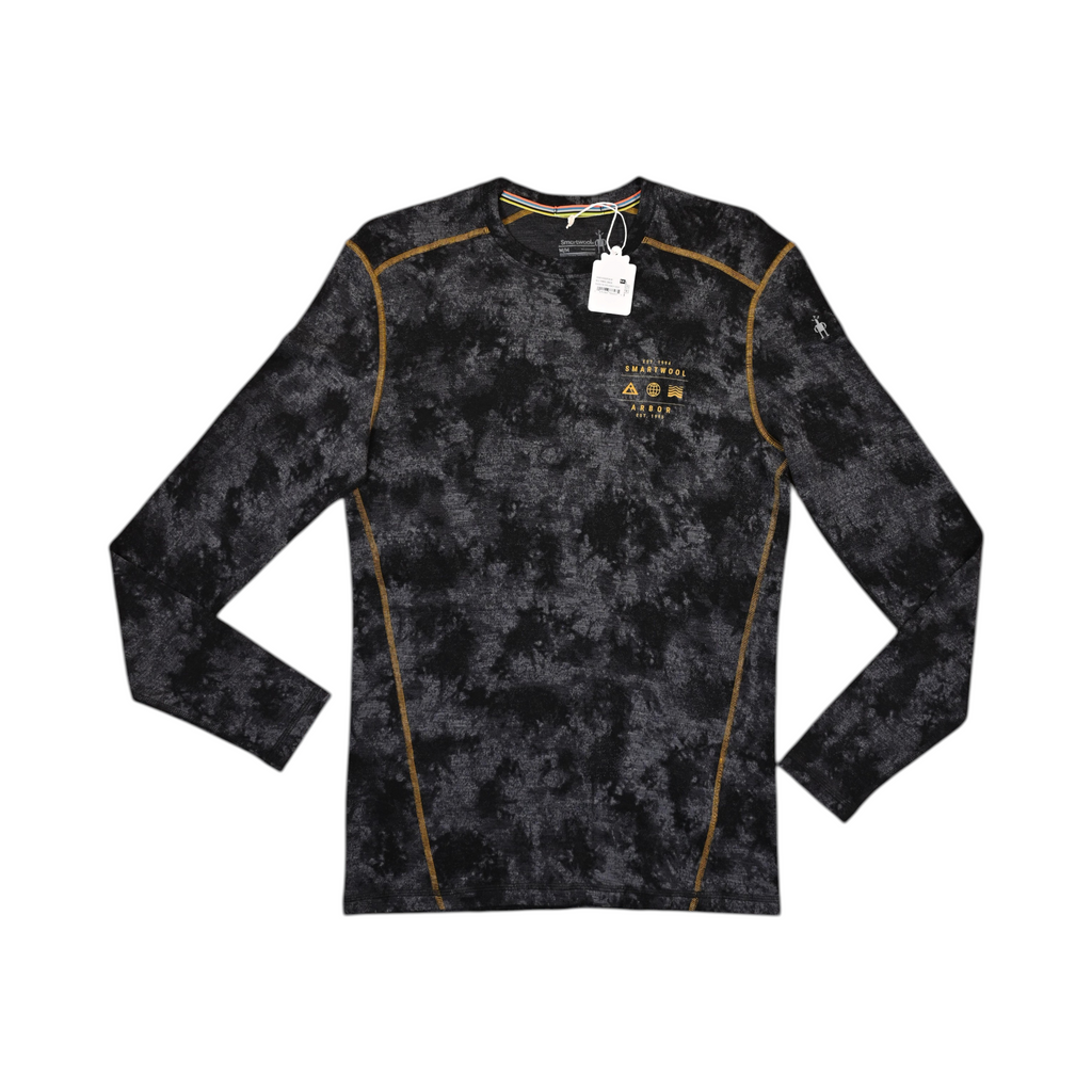 Black tie-dye crew neck baselayer by Smartwool with gold contrast stitching and Arbor Collective branding, laid flat.