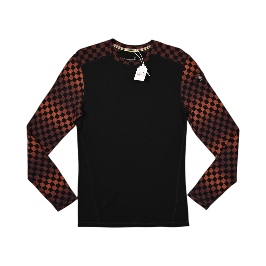 Black crew neck baselayer by Smartwool with rust-and-black checkerboard sleeves, laid flat.