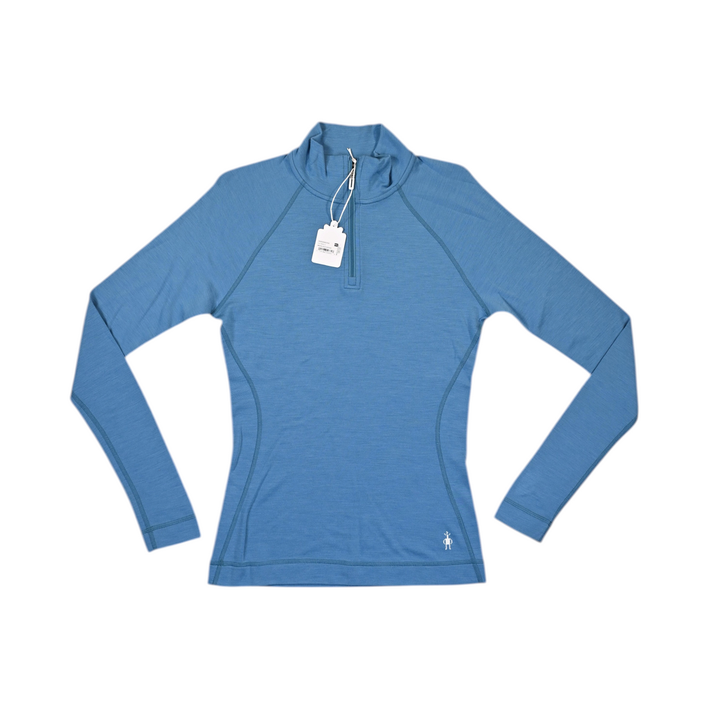 Solid medium blue Smartwool quarter-zip top laid flat, showing the collar and zip.