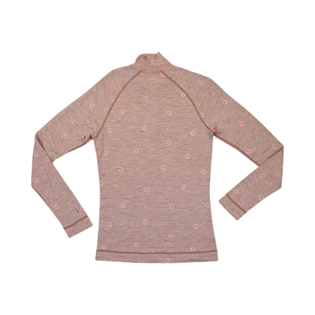 Detail view of a tan floral houndstooth print Smartwool quarter-zip top.