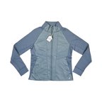Slate blue Smartwool hybrid jacket laid flat, showing the quilted front panel and fleece sleeves.