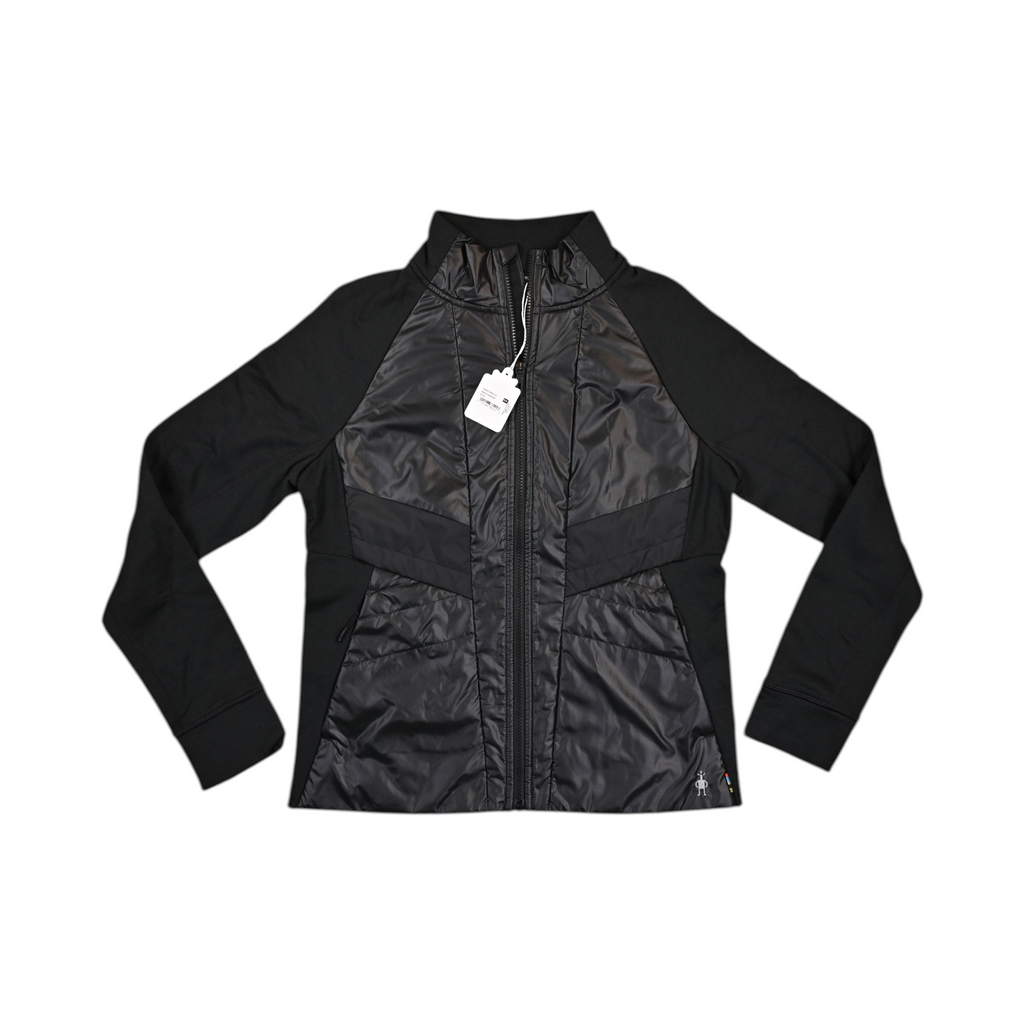 Black Smartwool hybrid jacket laid flat, showing the quilted front panel and fleece sleeves.