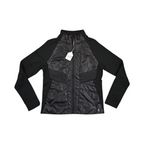 Black Smartwool hybrid jacket laid flat, showing the quilted front panel and fleece sleeves.