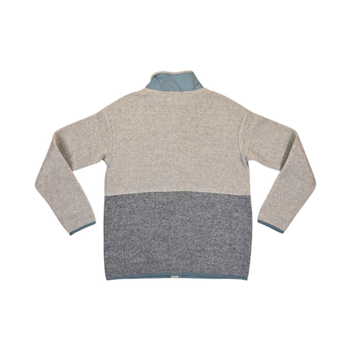 Back of an oatmeal and grey colorblock Smartwool fleece jacket laid flat.