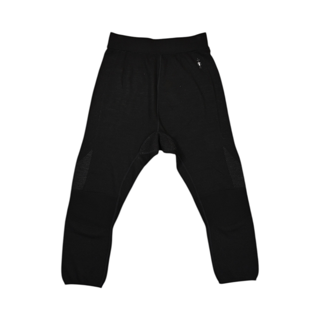Black 3/4-length baselayer pants by Smartwool, laid flat showing the calf-length hem.