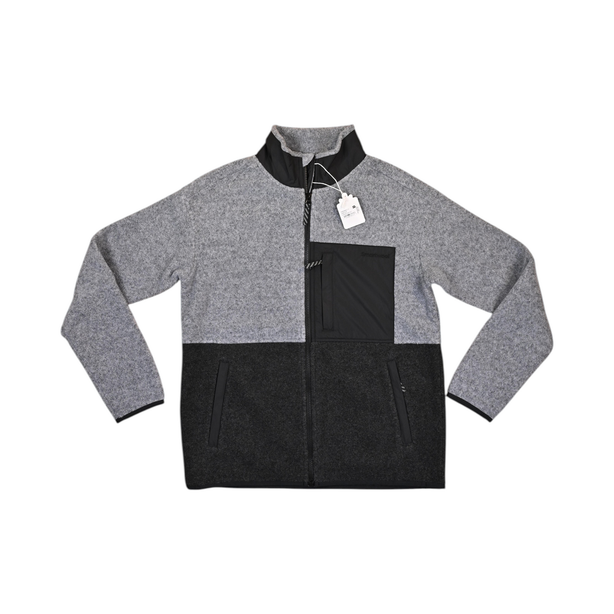 Light grey and charcoal colorblock Smartwool fleece jacket laid flat, showing the chest pocket and zip.