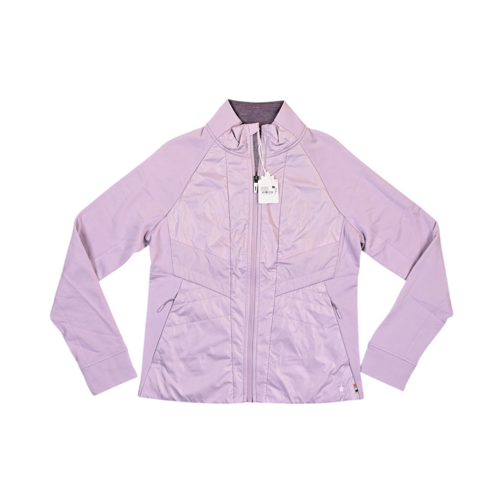 Pale lilac Smartwool hybrid jacket laid flat, showing the quilted front panel and fleece sleeves.