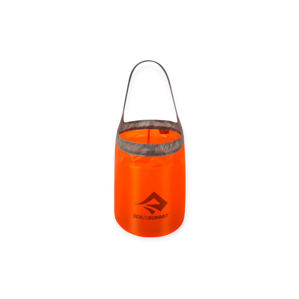 Red folding bucket by Sea to Summit with gray trim and a carrying handle.