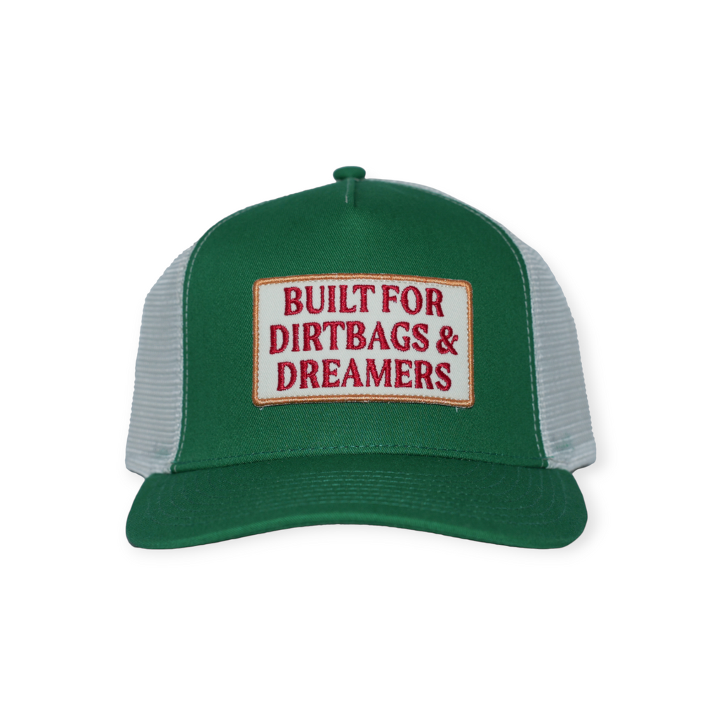 Green trucker hat by FERAL with a white mesh back and logo patch on the front.