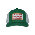 Green trucker hat by FERAL with a white mesh back and logo patch on the front.