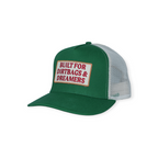 Green trucker hat by FERAL with a white mesh back and a rectangular "Built for Dirtbags & Dreamers" patch.