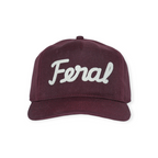 Burgundy wool hat by FERAL with a white, cursive "Feral" logo on the front.