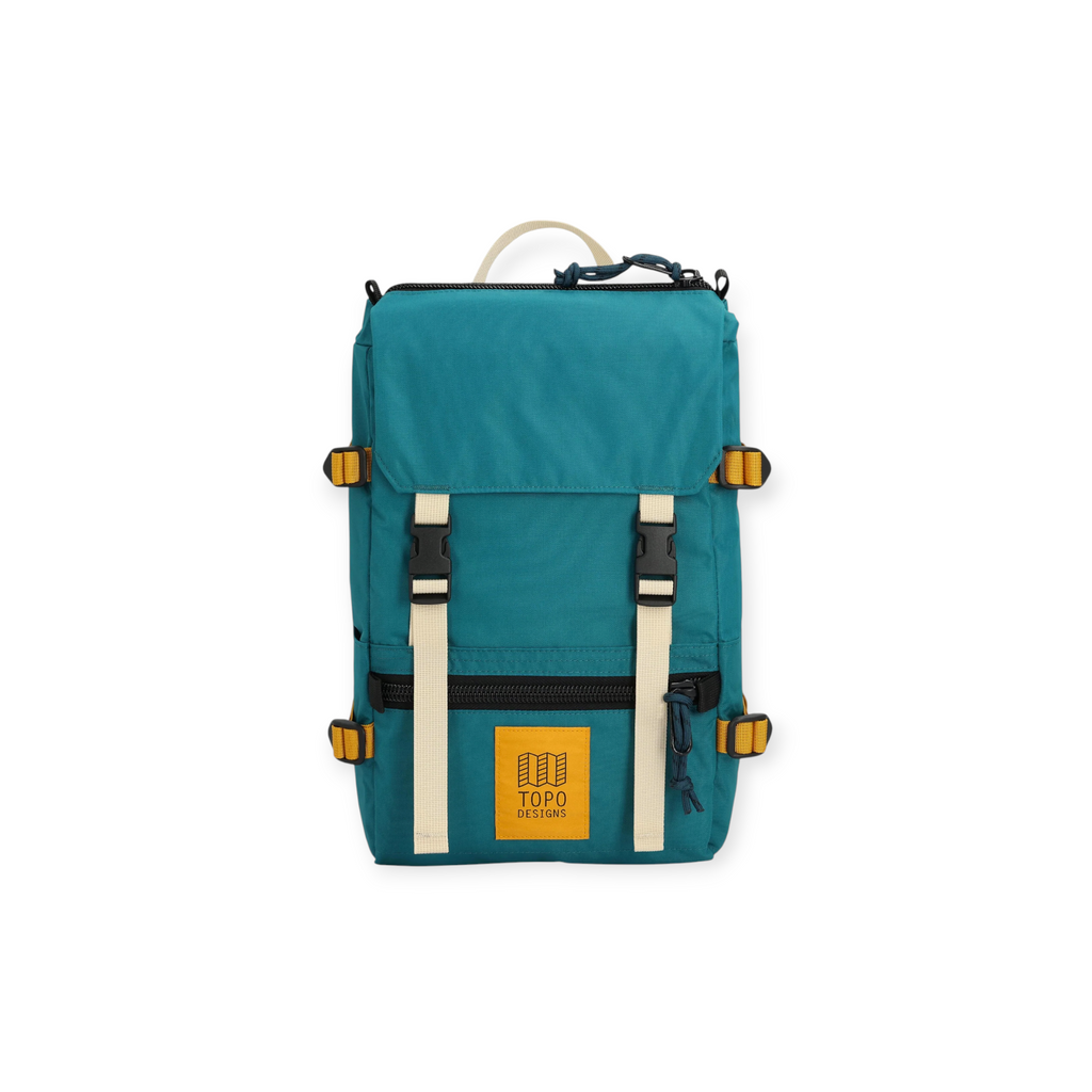 Teal Rover Pack Mini by Topo Designs with cream-colored straps, gold accents and a yellow logo patch.