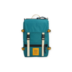 Teal Rover Pack Mini by Topo Designs with cream-colored straps, gold accents and a yellow logo patch.