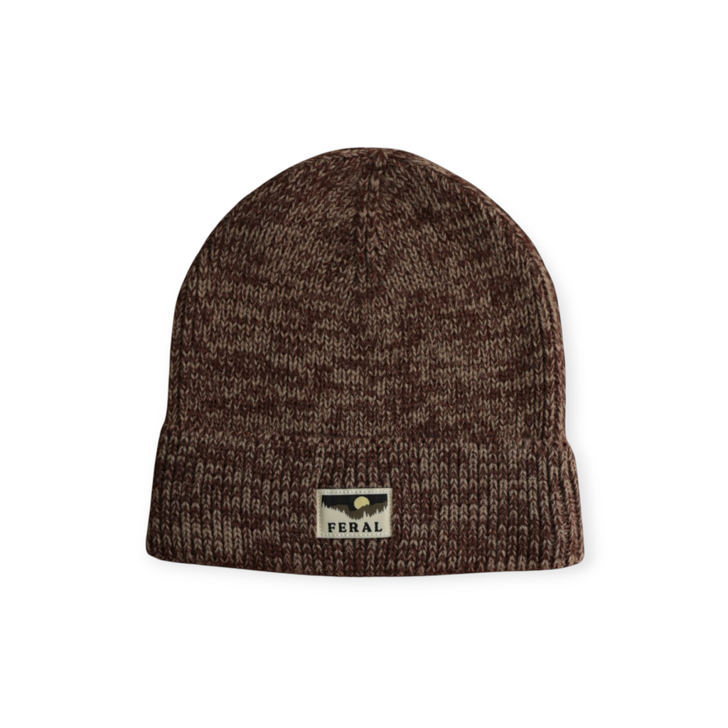 Brown knit beanie by FERAL, featuring a logo patch with a landscape and the brand name.