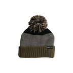 Knit beanie by FERAL with pom-pom, color-blocked olive, black and herringbone pattern.