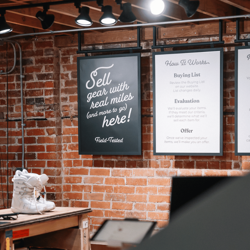 Brick wall with framed text and white boots on a table