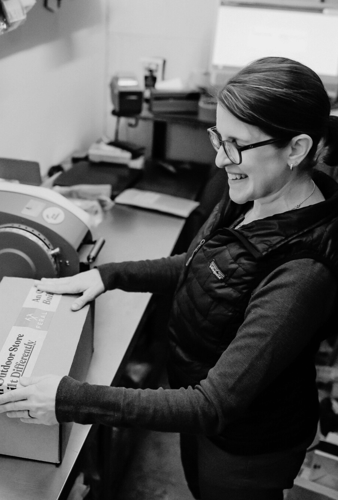 Person packaging a box in an office setting