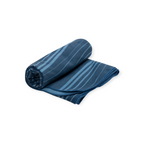 Blue Drylite towel large by Sea to Summit, partially rolled, with lighter blue wavy stripes.