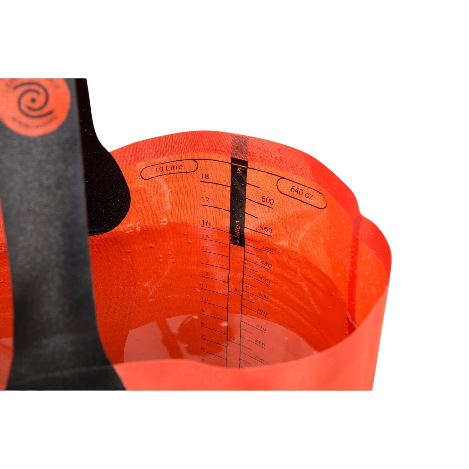 Red nylon folding bucket by Sea to Summit, showing the measurement scale and filled with water.