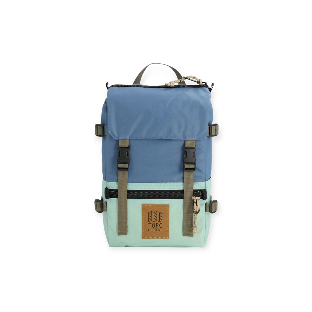 Blue and mint green backpack by Topo Designs with brown straps and logo patch.