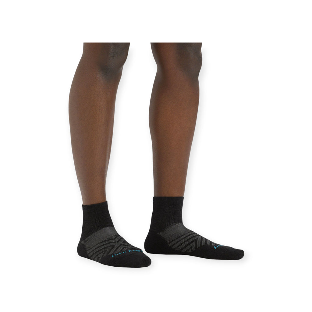 Black quarter running socks by Darn Tough with textured gray chevron detailing.