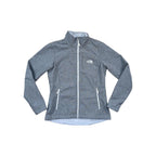 Gray softshell jacket by The North Face, with zippered pockets and a full zip front closure.