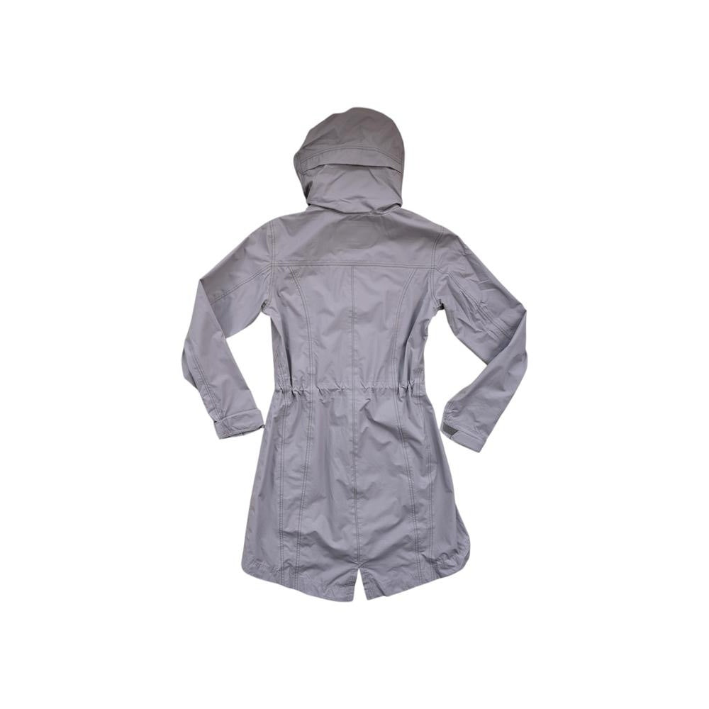 Grey trench rain shell jacket by Kuhl, seen from the back with a hood and drawstring waist.