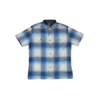 Blue button-up shirt by Kuhl, featuring a plaid pattern, short sleeves, and chest pockets.