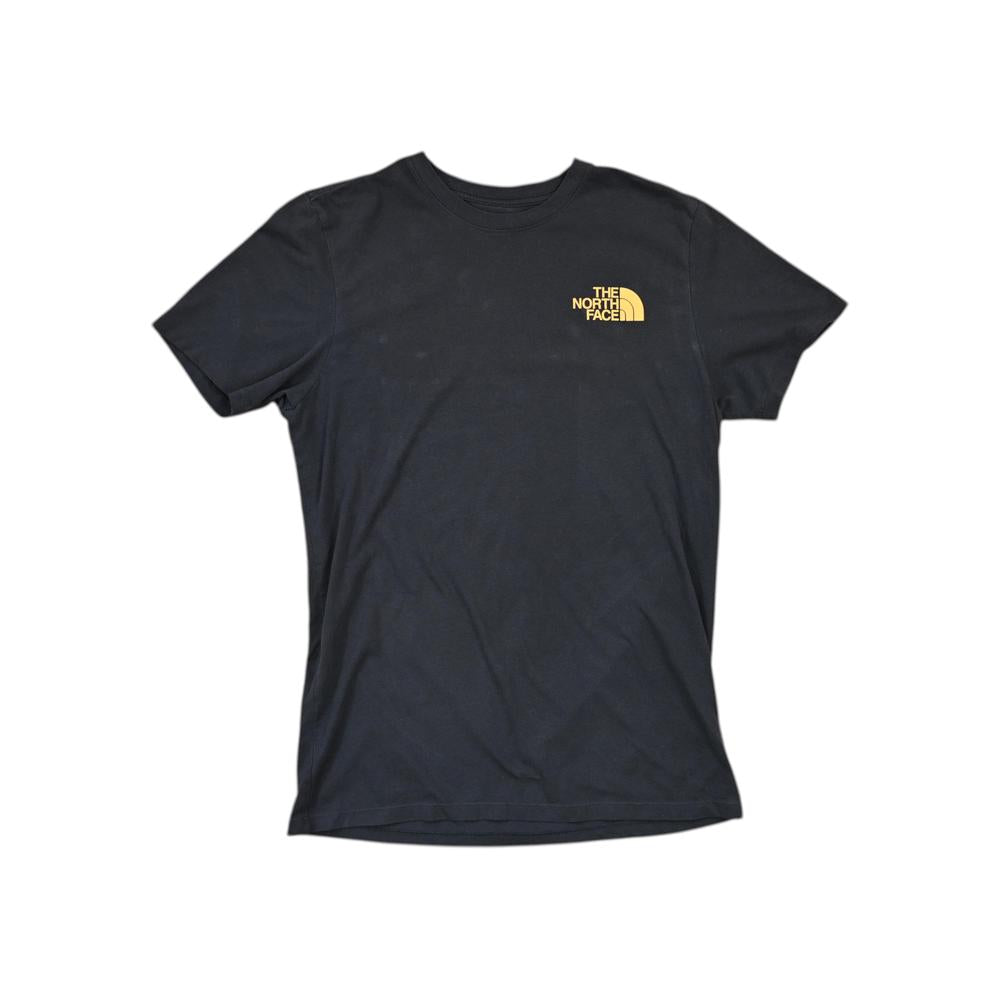 Black t-shirt by North Face with a yellow logo on the chest.
