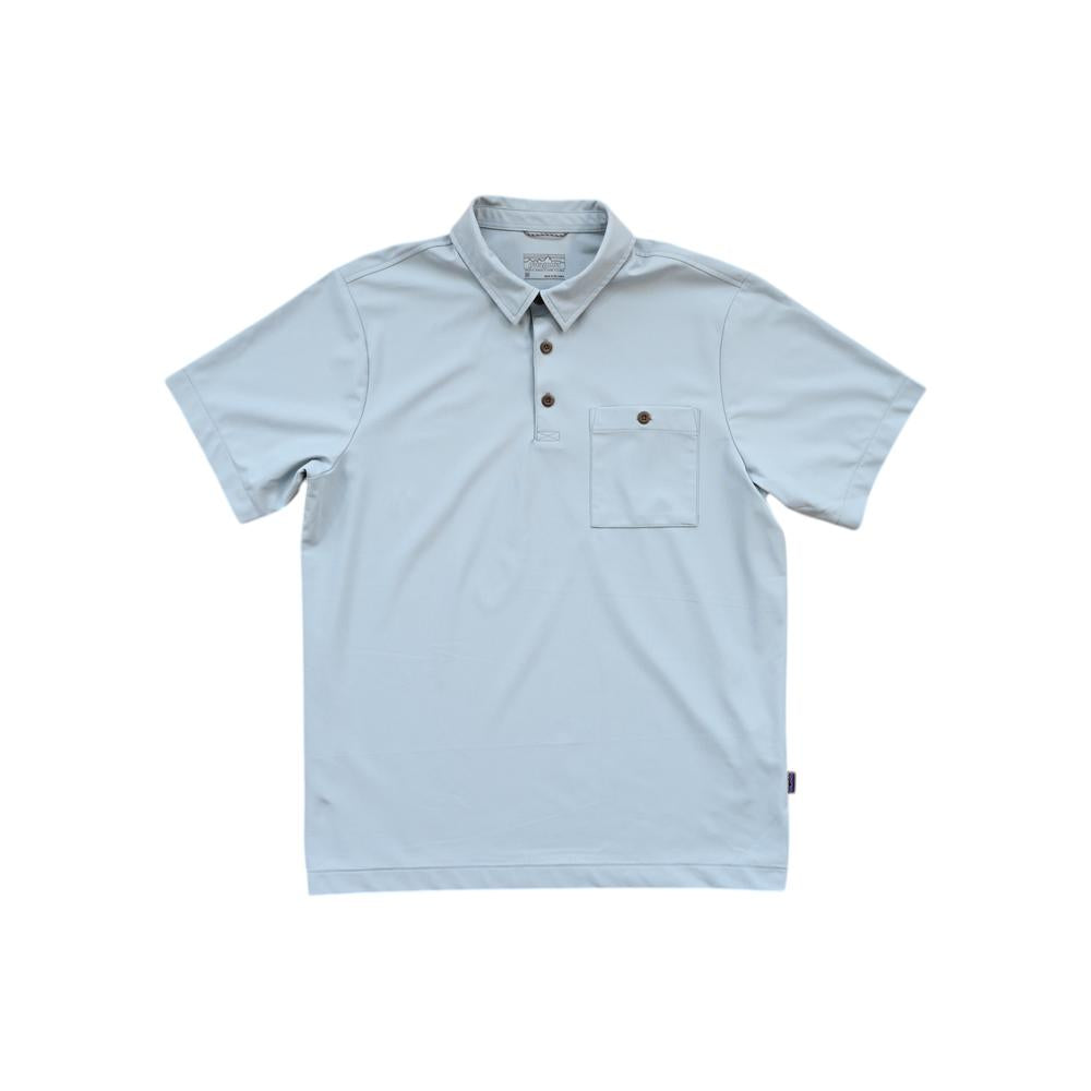 Blue polo shirt by Patagonia, with a patch pocket and brown buttons.