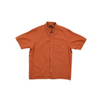 Orange button-up shirt by Marmot with a plaid pattern and a chest pocket.
